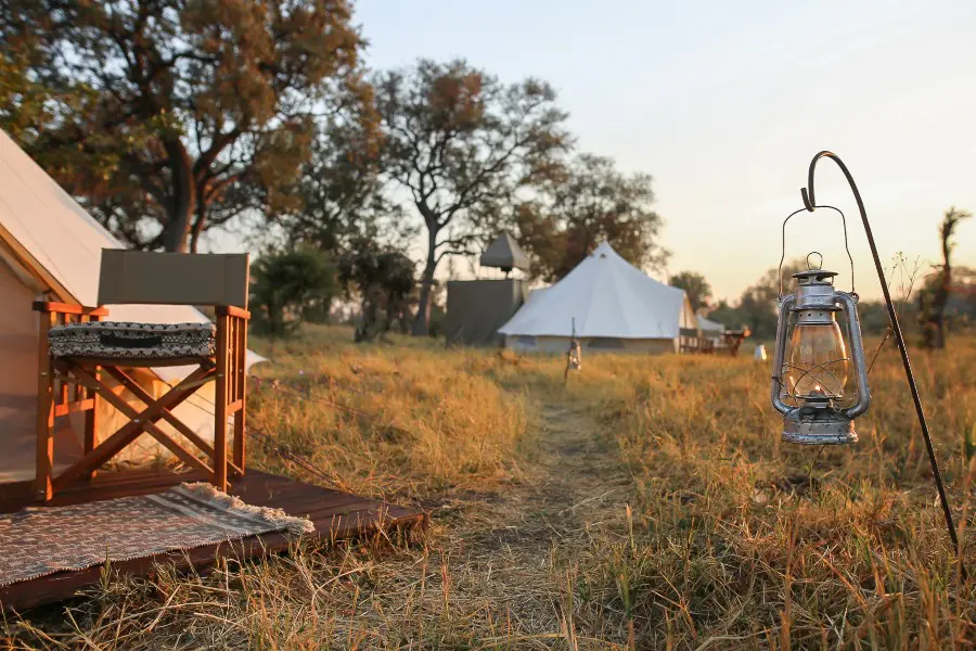 Lantern beside canvas safari tents at Feline Fields Vintage Camp | Go2Africa