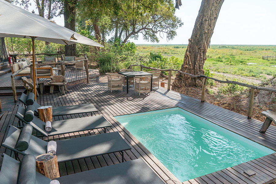 A plunge pool, pool loungers, and seating areas overlook Botswana's plains | Go2Africa