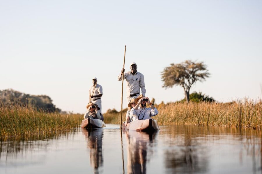 Guests enjoy a mokoro ride down a waterway driven by guides from Wilderness Jacana | Go2Africa