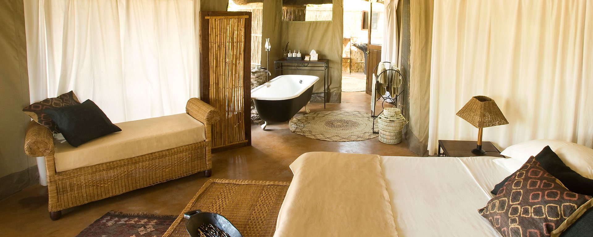 The spacious and luxurious tents at Mchenja Camp have open-air bath tubs and showers that look out over the river.