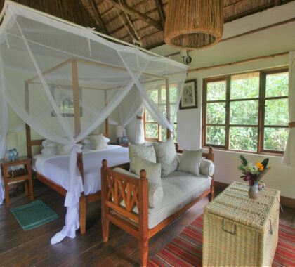 Cool decor & high-thatched ceilings ensure your suite at Volcanoes Bwindi is a welcome retreat.