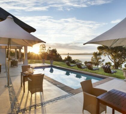 One of the two pools at The Thatch House Boutique Hotel, complete with lagoon & sunset views.