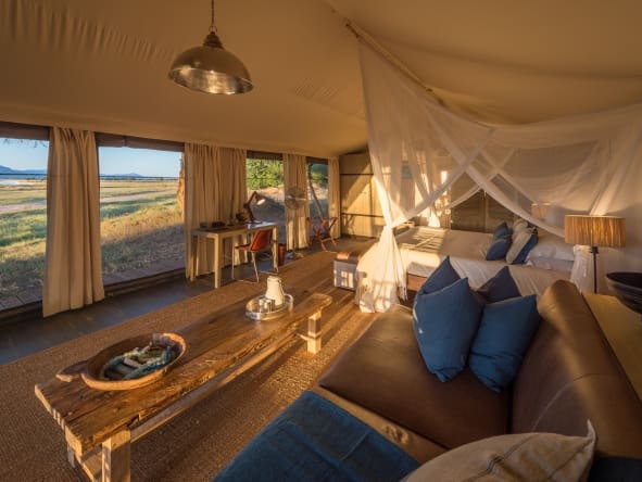 Luxury canvas tent opens onto a wooden deck with gorgeous views of the Zambezi River.