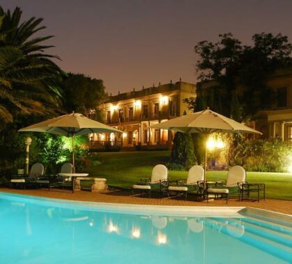 Enjoy a glass of wine beside the pool on a warm summer evening