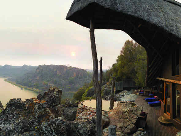 The lodge is positioned on a rocky outcrop, with beautiful views of Lake Malilangwe.