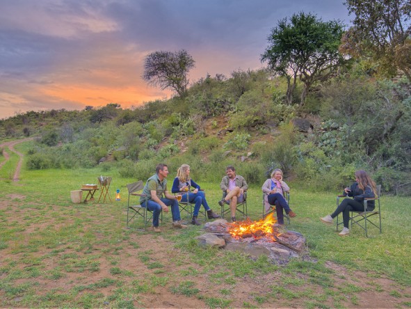 A safari evening is a time for refreshing drinks around the camp fire.