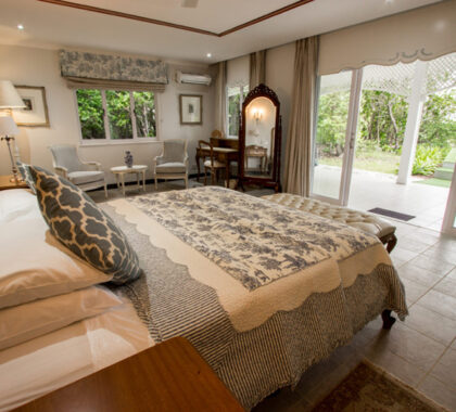 Villas have expansive bedrooms that open directly onto the white angelic beach.