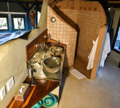 The en suite bathroom has a large shower and two basins.