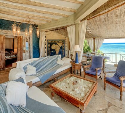 The spacious verandah is furnished with hand-carved sofas that are perfectly positioned to soak up the spectacular ocean views.