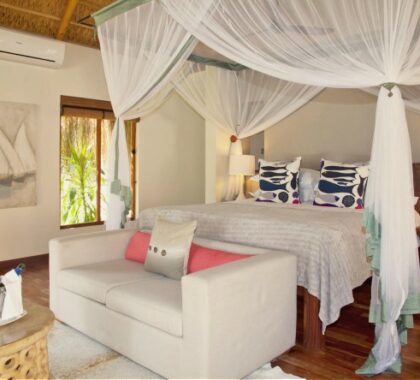 Rooms have a beach-chic style complimented by beautifully carved furniture and traditional artwork.