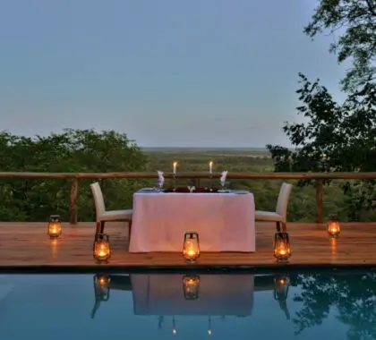 A romantic dinner set up by the pool for honeymooners. 