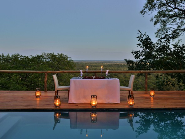 A romantic dinner set up by the pool for honeymooners. 