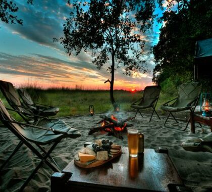 Take in the spectacular African sunset as you enjoy a chilled drink around the campfire.