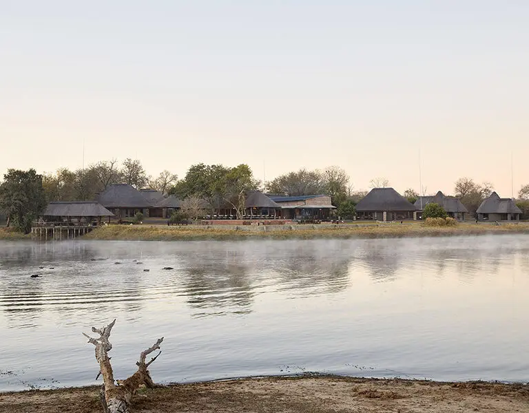 Arathusa Safari Lodge overlooks a large waterhole with resident hippos. 