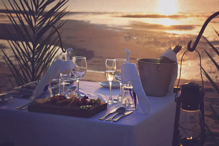 A romantic private sunset dining setup at Azura Benguerra.