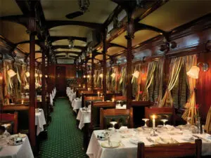 Polished silverware reflects candlelight in the dining car - formal dress is required for dinner.