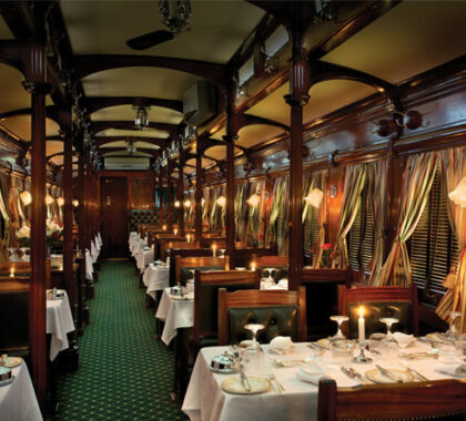 Polished silverware reflects candlelight in the dining car - formal dress is required for dinner.