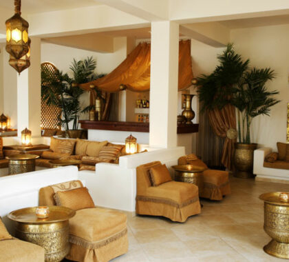 The lounge is decorated in shades of white, cream and gold, with authentic lighting and wood detail.