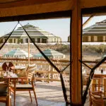The indoor dining area leads out onto the pool and viewing deck where you can look out over the wilderness and a waterhole.