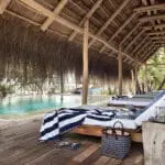 Plush sun loungers next to the pool.