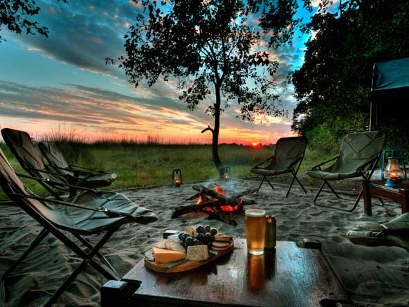 End off the day the safari way: a comfortable seat & your favourite chilled drink, set to an open fire & the sunset.