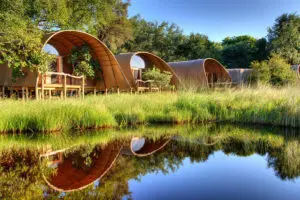 Camp Okuti rooms overlooking a water channel. 