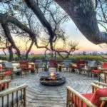 Cosy up to a fire at Camp Xakanaxa's.