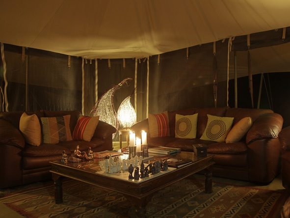 Candles and lantern create an ambient and cosy atmosphere in the traditional Meru-style camp.
