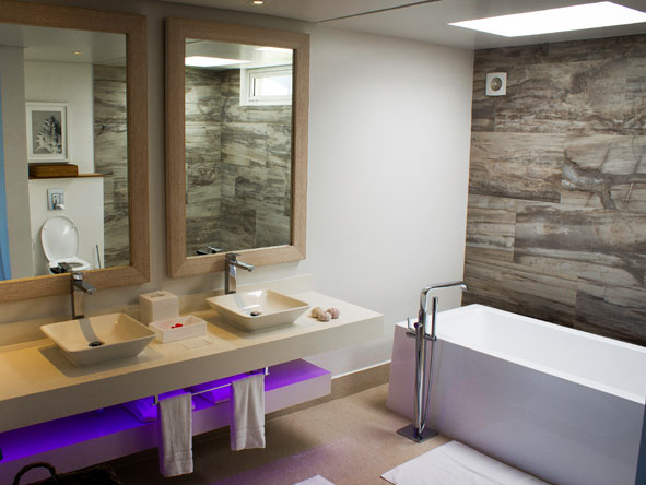 En suite bathrooms are chic and contemporary, and some feature bathtubs as well as showers.
