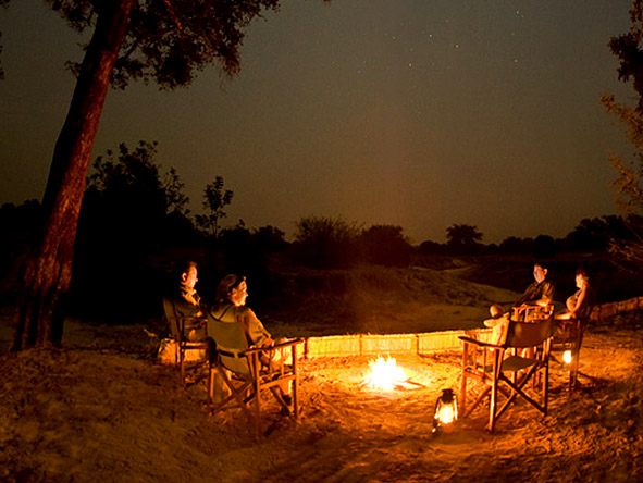 After dinner, draw your chair closer to the fire & absorb the sounds of the African night.