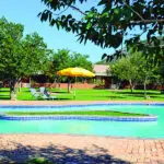 The large swimming pool at the centre of the lodge is the perfect place to cool off after exploring the scenic Damaraland area.