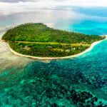 Aerial view of Denis Private Island and the surrounding crystal clear water.
