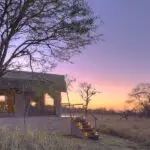 Dunia Camp tent exterior at sunrise. 