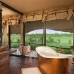 Each tent at Somalisa Camp in Zimbabwe has an indoor and outdoor shower, as well as a copper slipper-style bathtub.