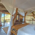 Each bedroom features eclectic style and decor, including hand-crafted wooden beds.