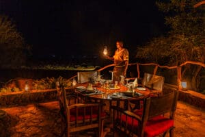 In the evening, the camp is lit up to provide a soft light over the outdoor dining area.