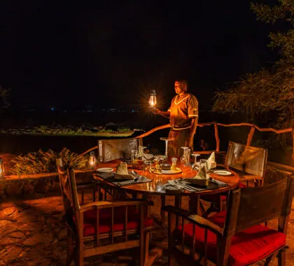 In the evening, the camp is lit up to provide a soft light over the outdoor dining area.