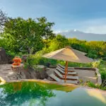 Return to camp after a morning's game drive and enjoy a refreshing swim in the rim-flow pool.