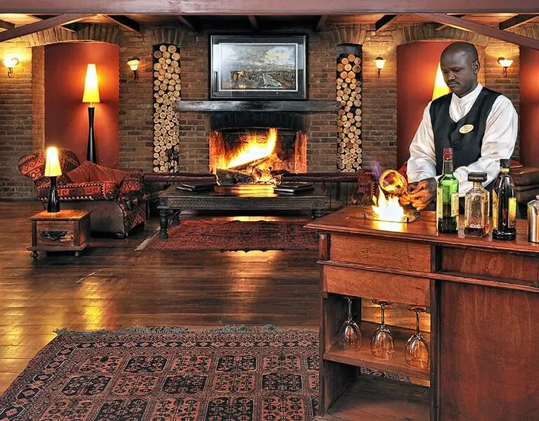 The warm and welcoming main lodge area of Arusha Coffee Lodge.