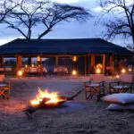 End the day the Asilia way- comfortable chairs, tall drinks & bubbly conversation around a campfire.