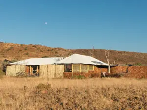 En suite bathrooms feature water-wise bucket showers, flush toilets & solar-heated water.