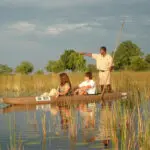 Exploring wild wetlands by canoe is part of the experience at Desert & Delta's Okavango camps.