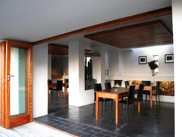 The dining area is a modern building with folding doors opening onto the terrace in front
