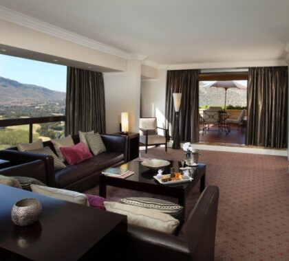 The Luxury Suites at The Cascades Hotel have a spacious lounge area with views of the distant mountains.