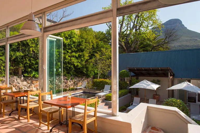 Sunny dining room overlooking the garden and swimming pool terrace.