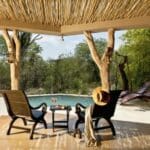 The luxury villas feature private pools and shaded patios overlooking the African bush.