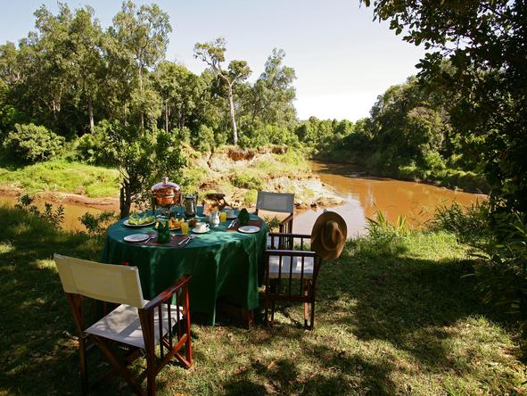 Enjoy a meal in the bush overlooking the Mara River.