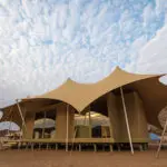 The camp's tented suites are a masterclass in innovative design & artistic appeal.