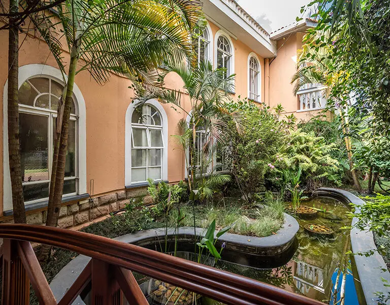 Cross over the peaceful koi fish pond to enter the house.