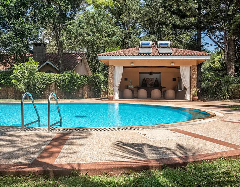 The pool pavillion with a view of the Poolside Cottage. 